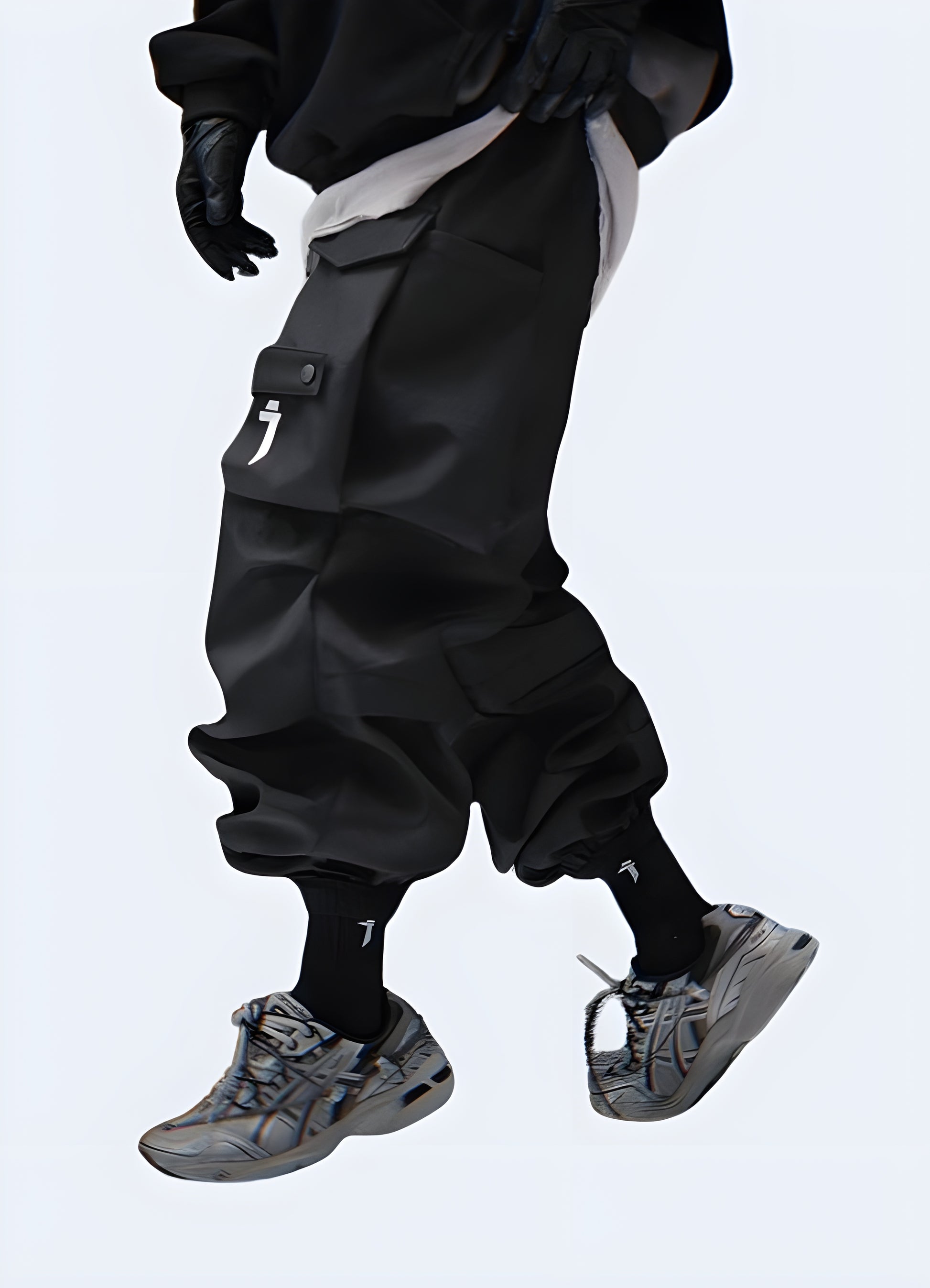 The pants feature a slim, tapered fit with a matte black finish and multiple utilitarian pockets.