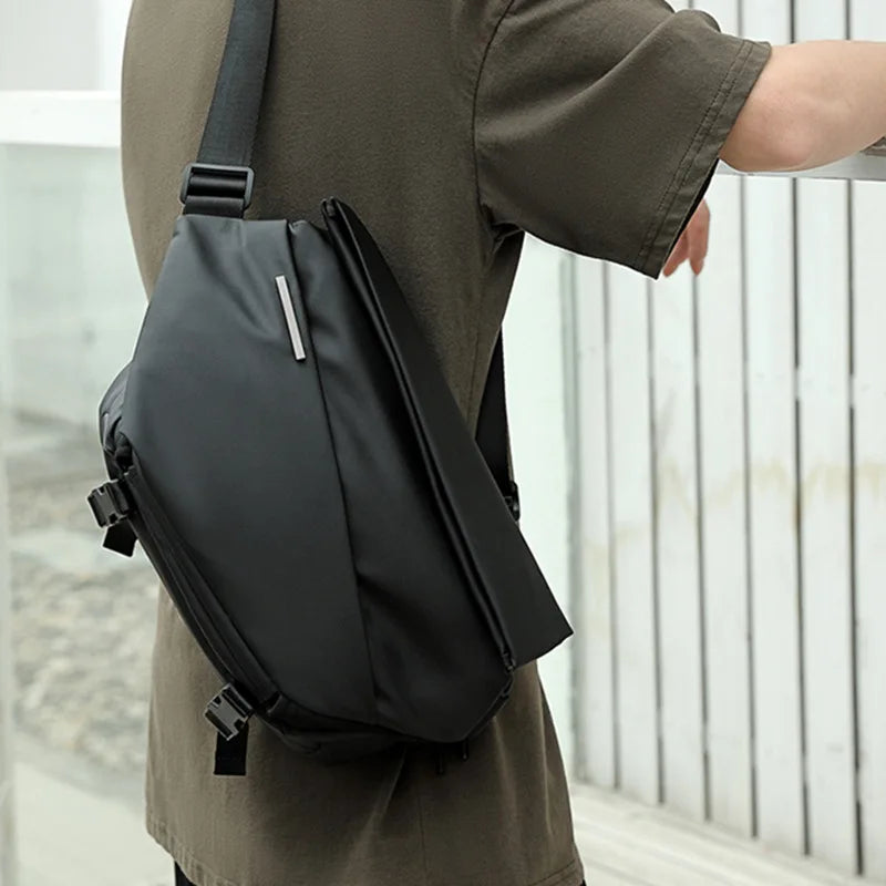 Man wearing a minimalist crossbody bag, front view, showcasing modern fashion. Ideal for a stylish and functional look.