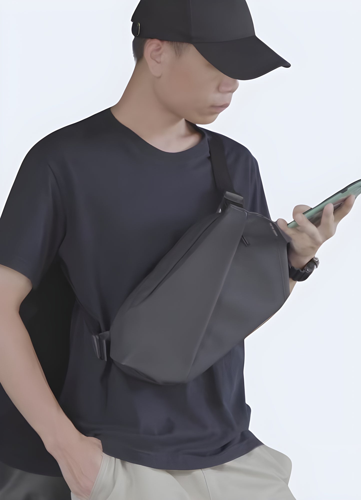 Man wearing a techwear crossbody bag, front view, showcasing futuristic fashion. Ideal for a modern and edgy style.