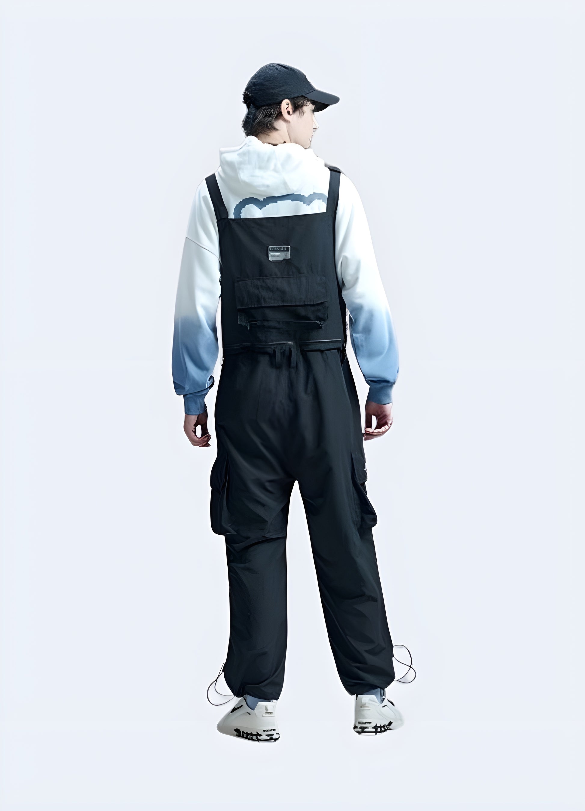 Back view of men's techwear overalls featuring multiple pockets and a modern utilitarian style.