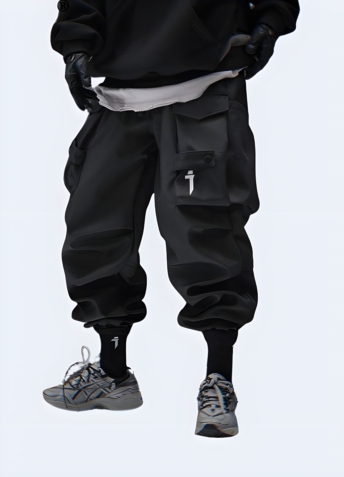 The pants have a slim, tapered fit with multiple utilitarian pockets, including large thigh pockets with zippers and smaller compartments.