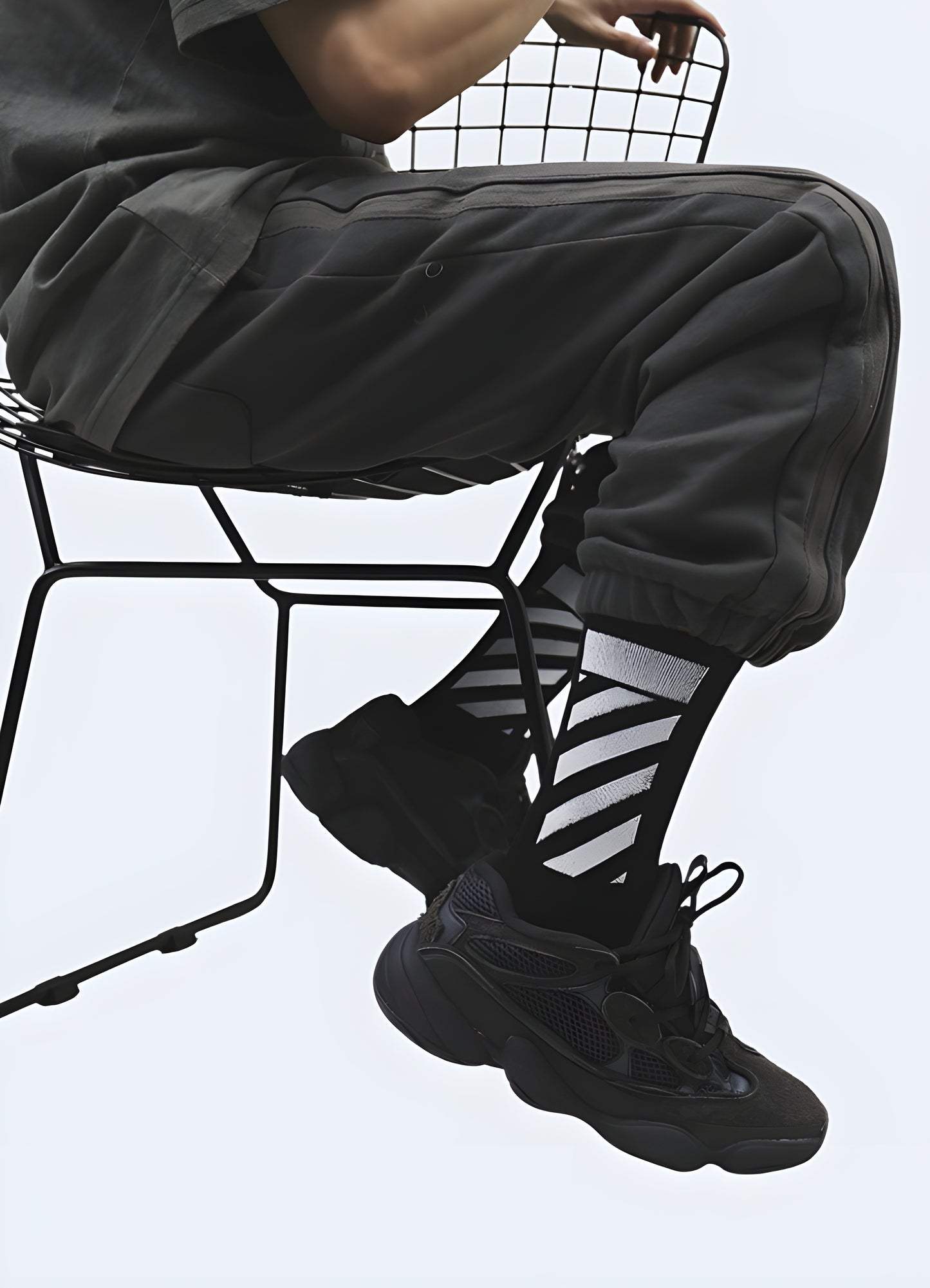 Side view of a man wearing futuristic socks, highlighting the intricate patterns and cutting-edge design tech enthusiasts.