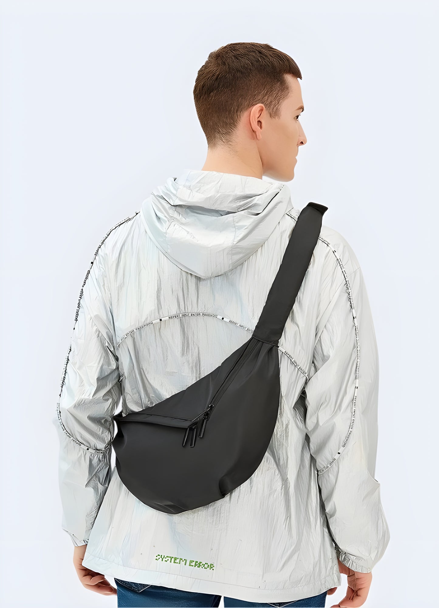 Front view of person wearing urban sling bag – sleek and functional chest bag with multiple compartments, secure zipper closure, black crossbody design ideal for techwear or urban outfits.