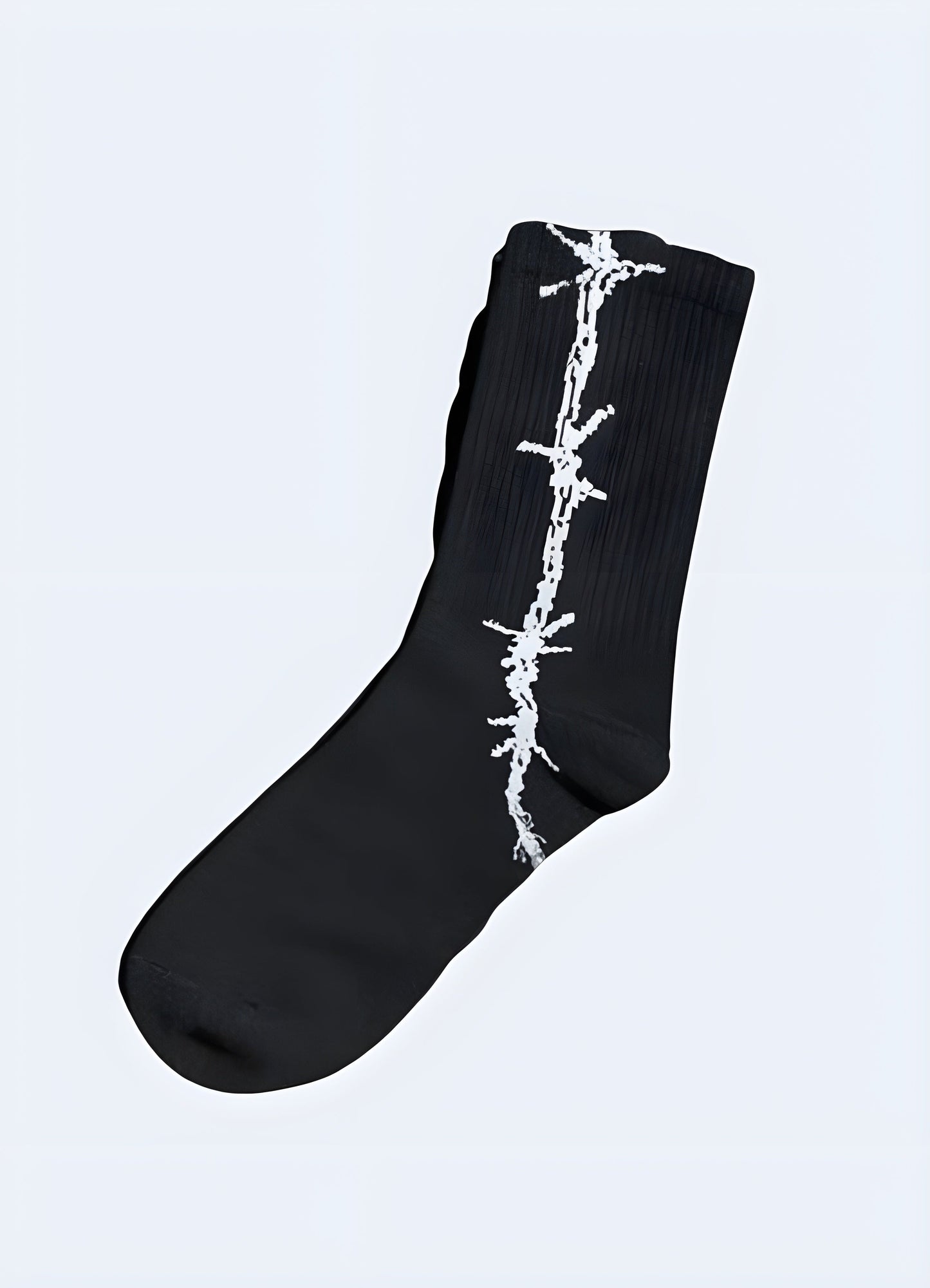 Black barbed wire socks, side view on model. Trendy socks showcased on a model.