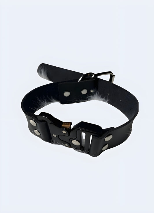 The buckle hangs from a sturdy leather necklace that drapes comfortably around the neck.