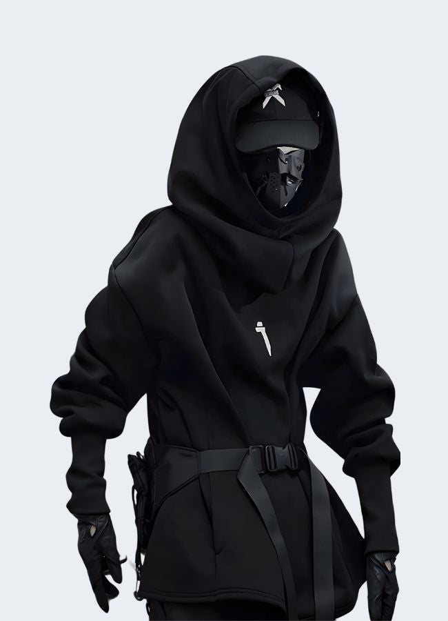 Front view of a model wearing a black hoodie, showcasing streetwear style. The hoodie has a minimalist design, perfect for a casual urban look.