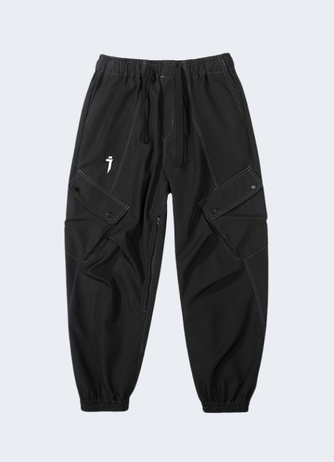 Dark grey cargo pants, worn by model, urban techwear streetwear.