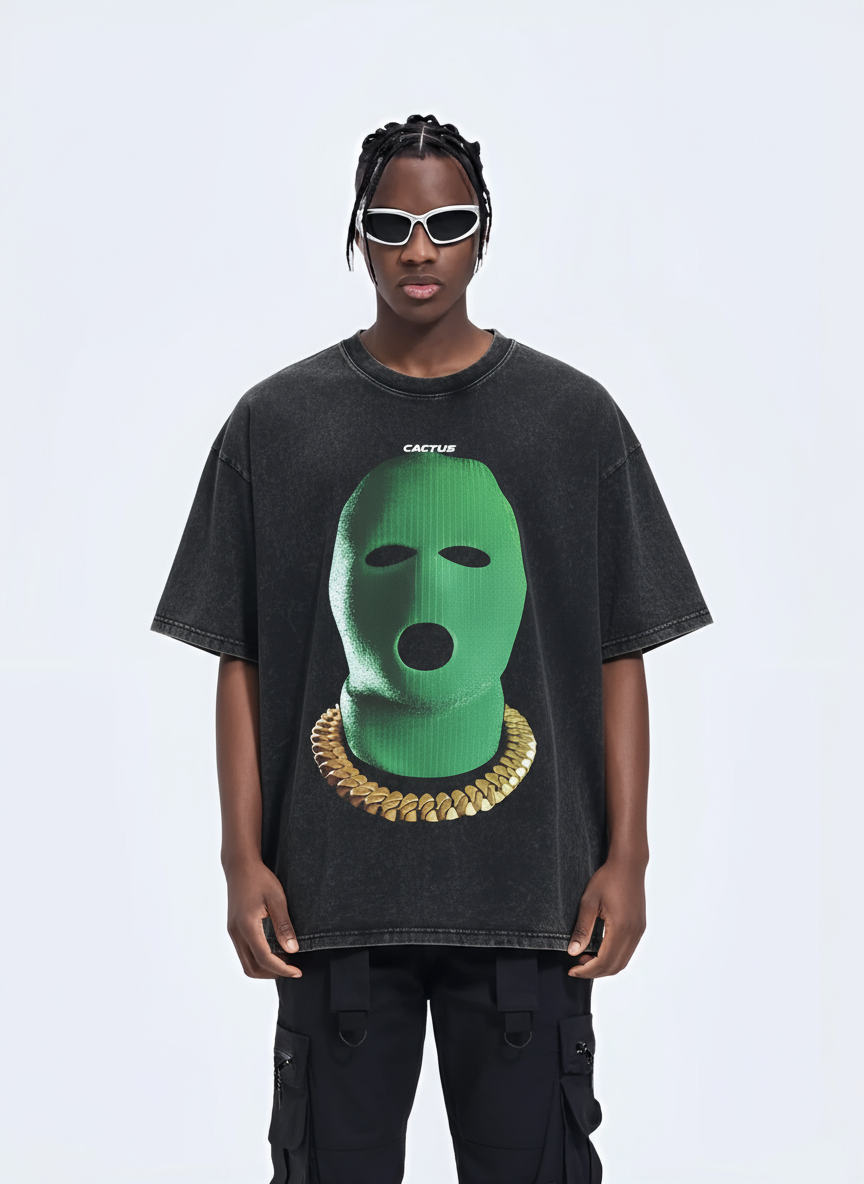 Person wearing a black t-shirt with a green graphic design on a white background