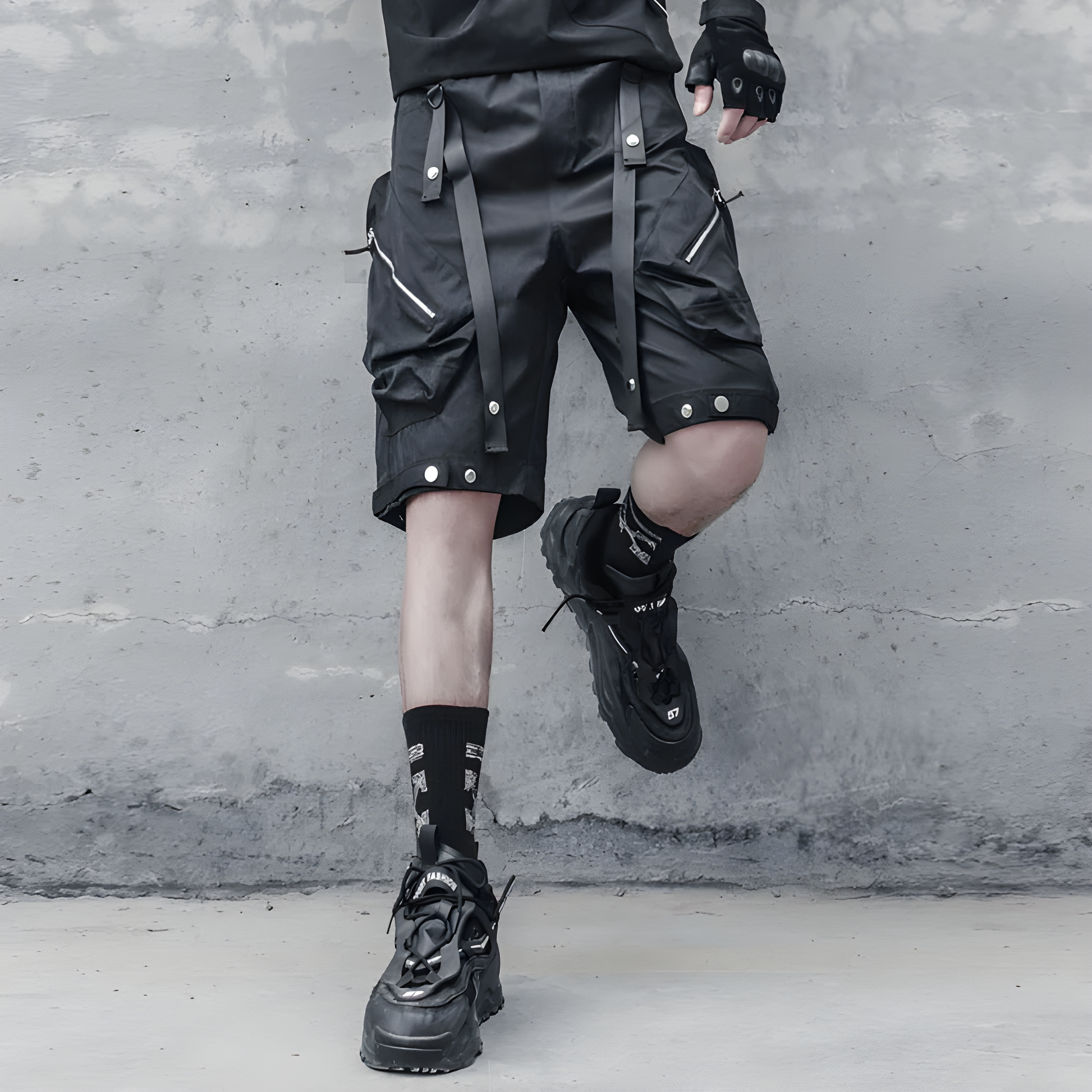 Man wearing technical shorts in black, front view, showcasing the functional design and sleek aesthetic suitable for urban techwear fashion in the AU.