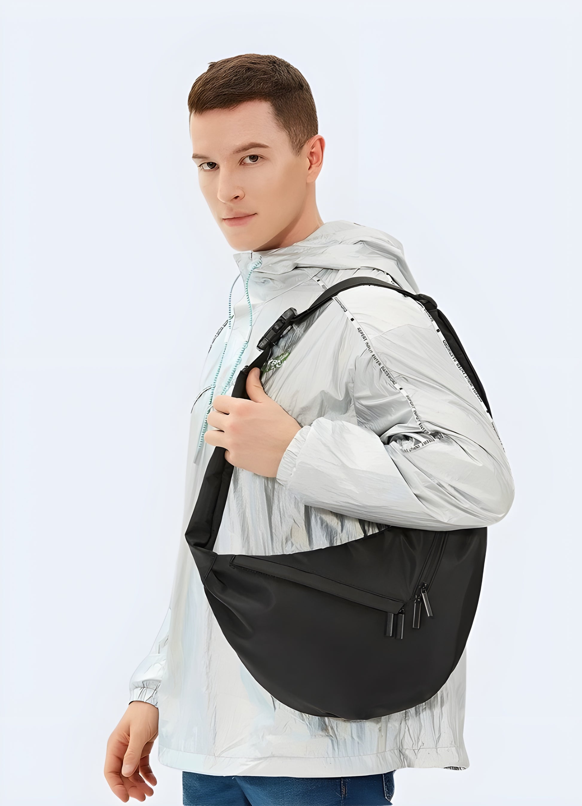 Side view of man wearing urban sling bag – minimalist and compact design, adjustable strap for comfort, techwear-inspired accessory ideal for everyday carry and travel, black crossbody bag for men.