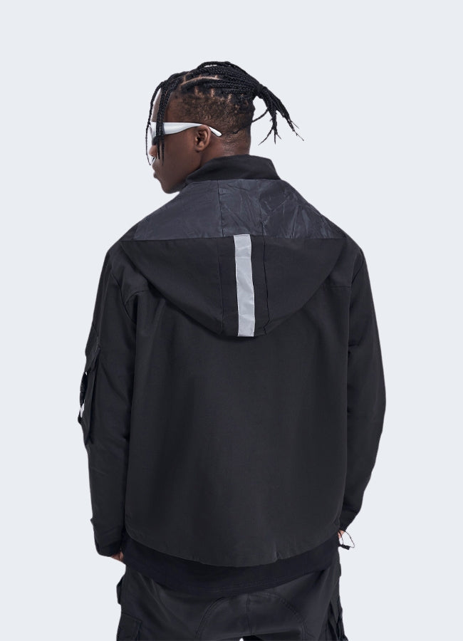 Men wearing black techwear jacket back side view.