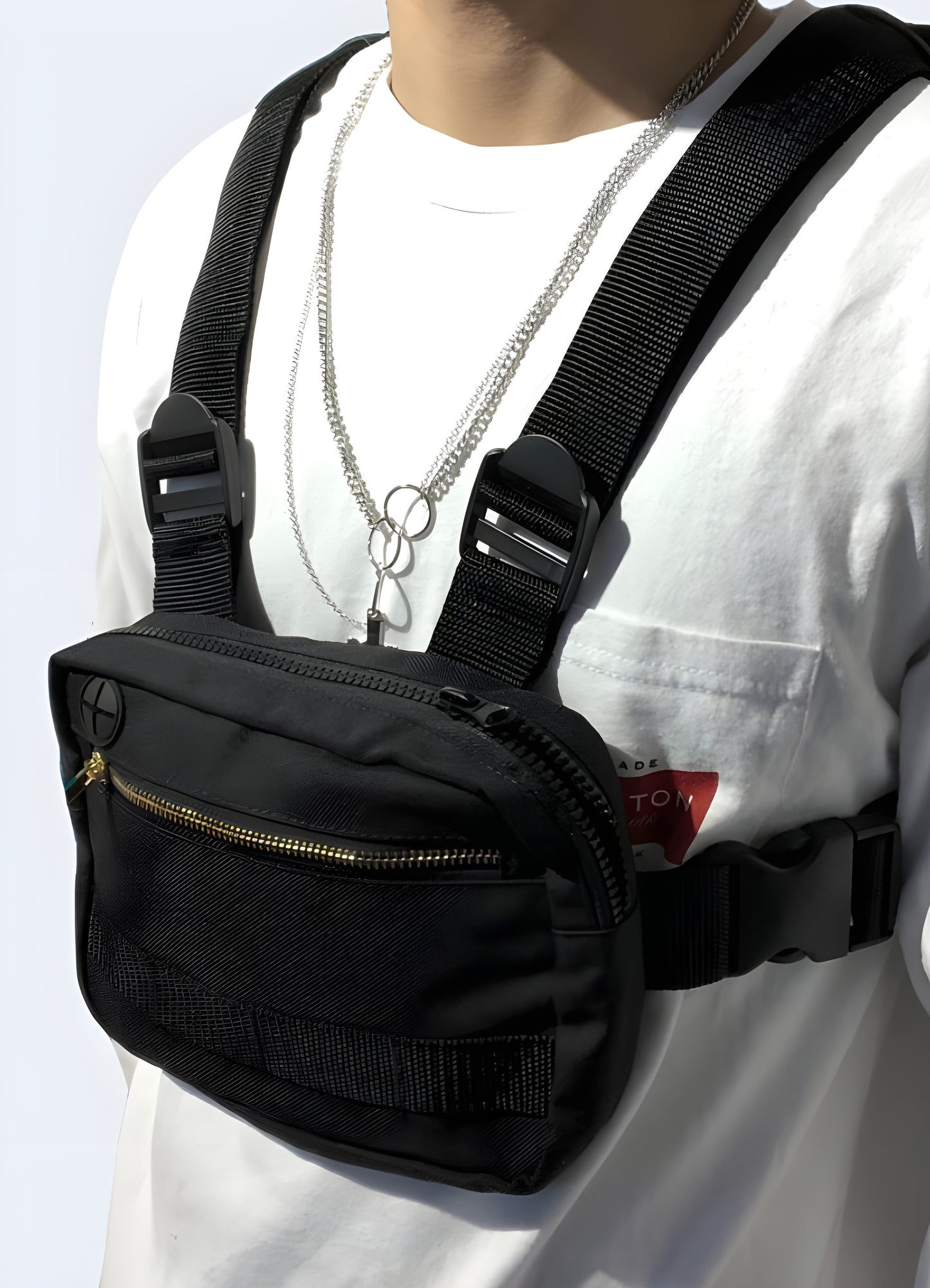 A functional and stylish accessory designed to be worn across the torso. The bag is positioned on the wearer's chest, providing easy access to essentials while maintaining a sleek and contemporary appearance.