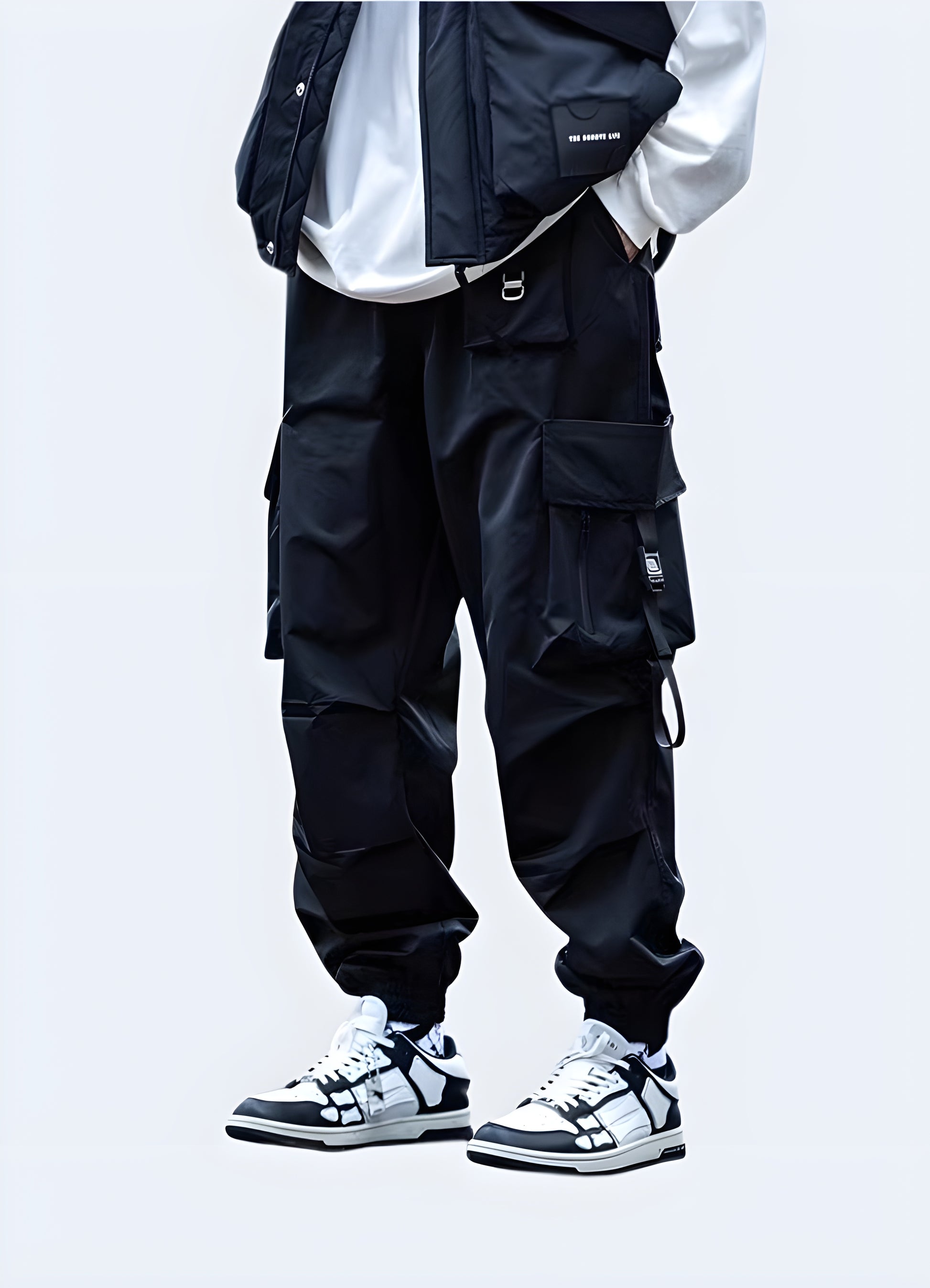 Man wearing black Japanese techwear cargo pants with adjustable straps and tapered fit, front view, AU fashion.