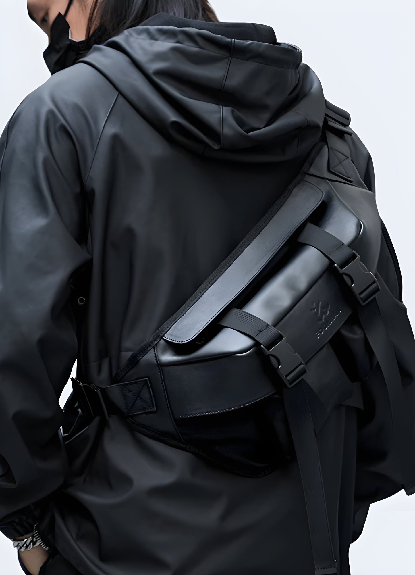 Man wearing a sling bag with streetwear, side view, highlighting trendy urban fashion. Perfect for a stylish and practical look.