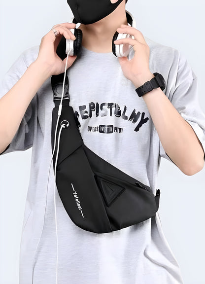 Man wearing a tactical crossbody bag, front side view, highlighting its rugged design.