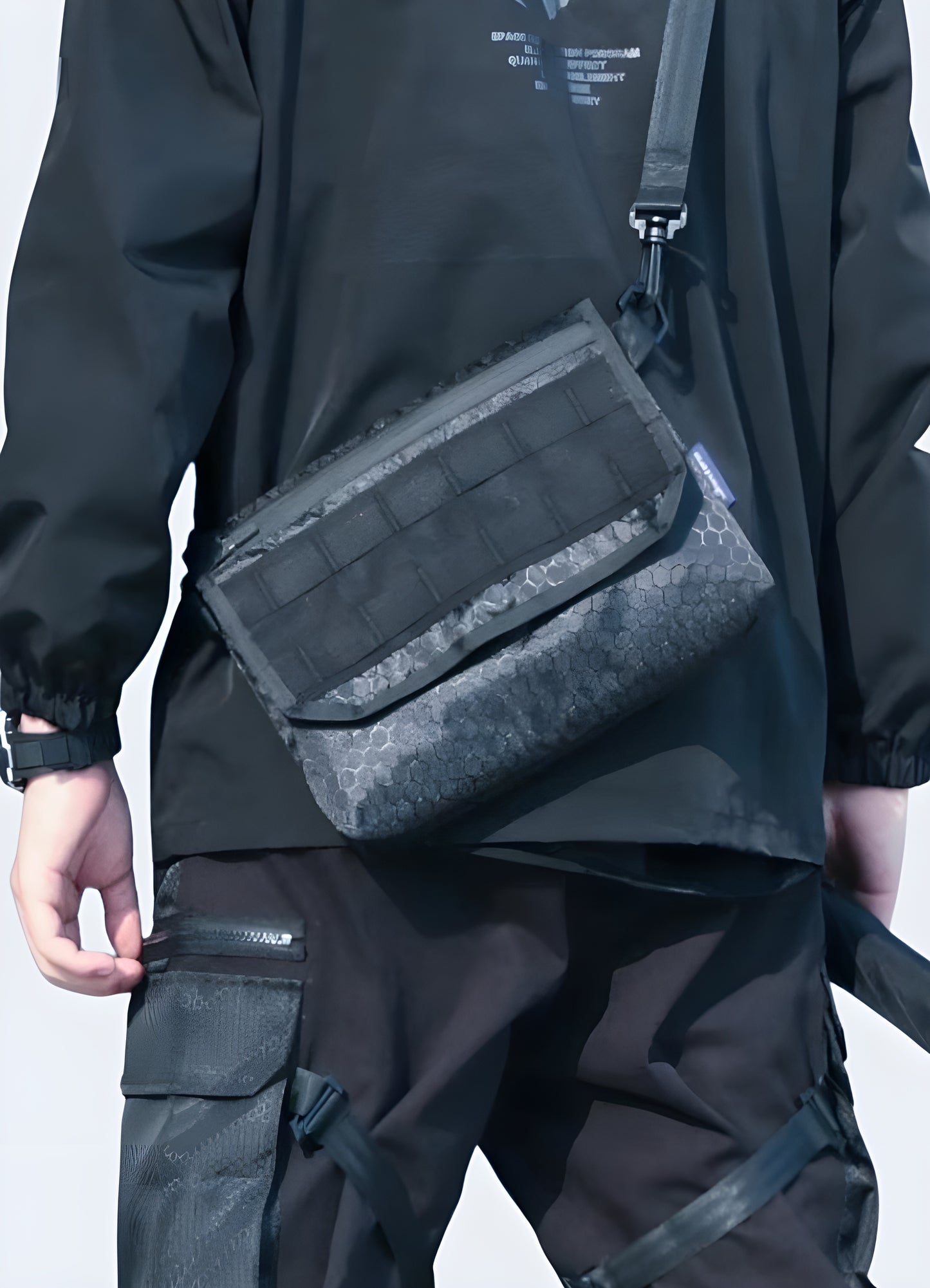 Man wearing a techwear shoulder bag, front view, highlighting urban style. Perfect for a modern and functional outfit.