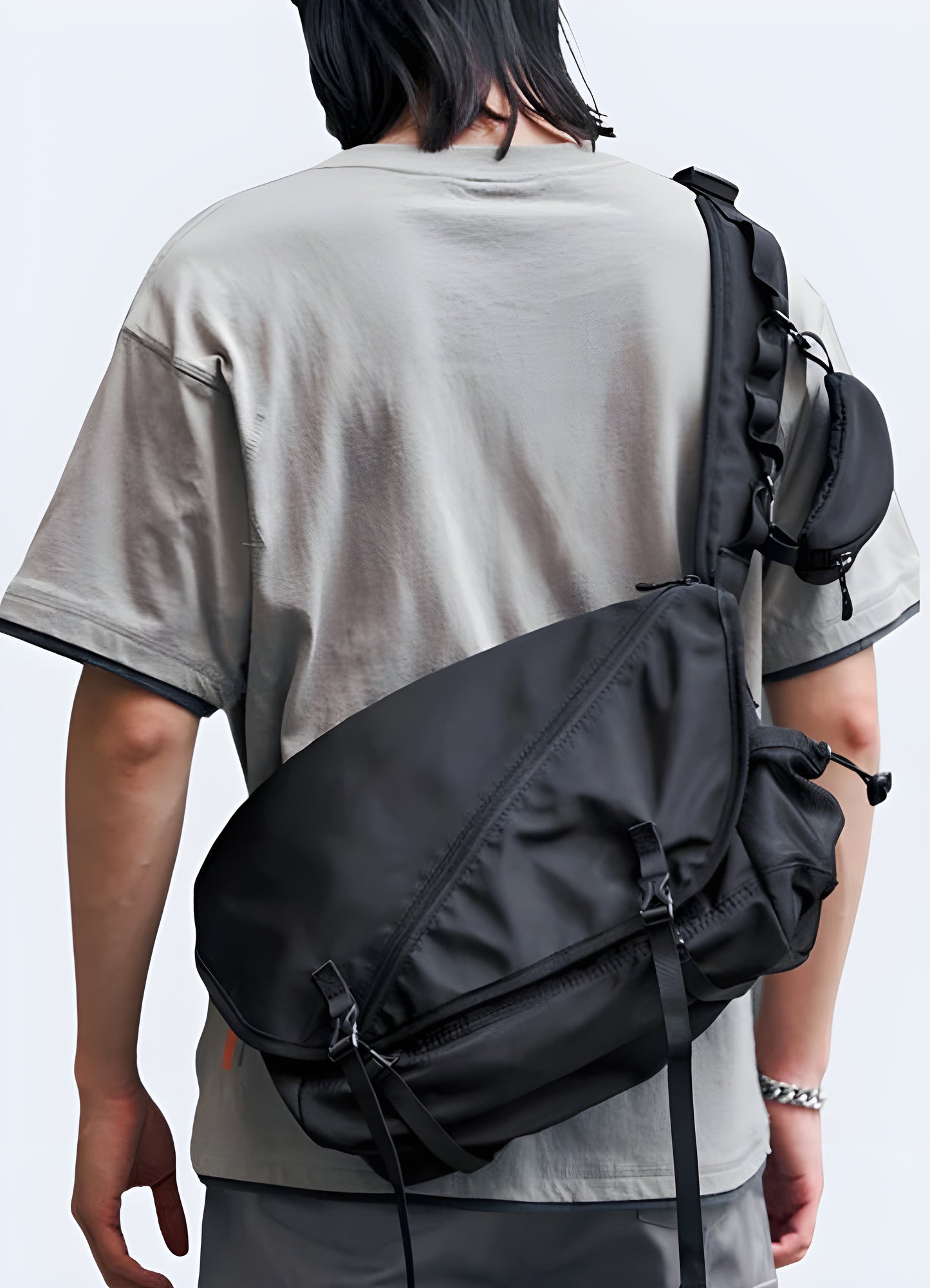 Man wearing a waterproof crossbody bag, front side view, highlighting its functionality.