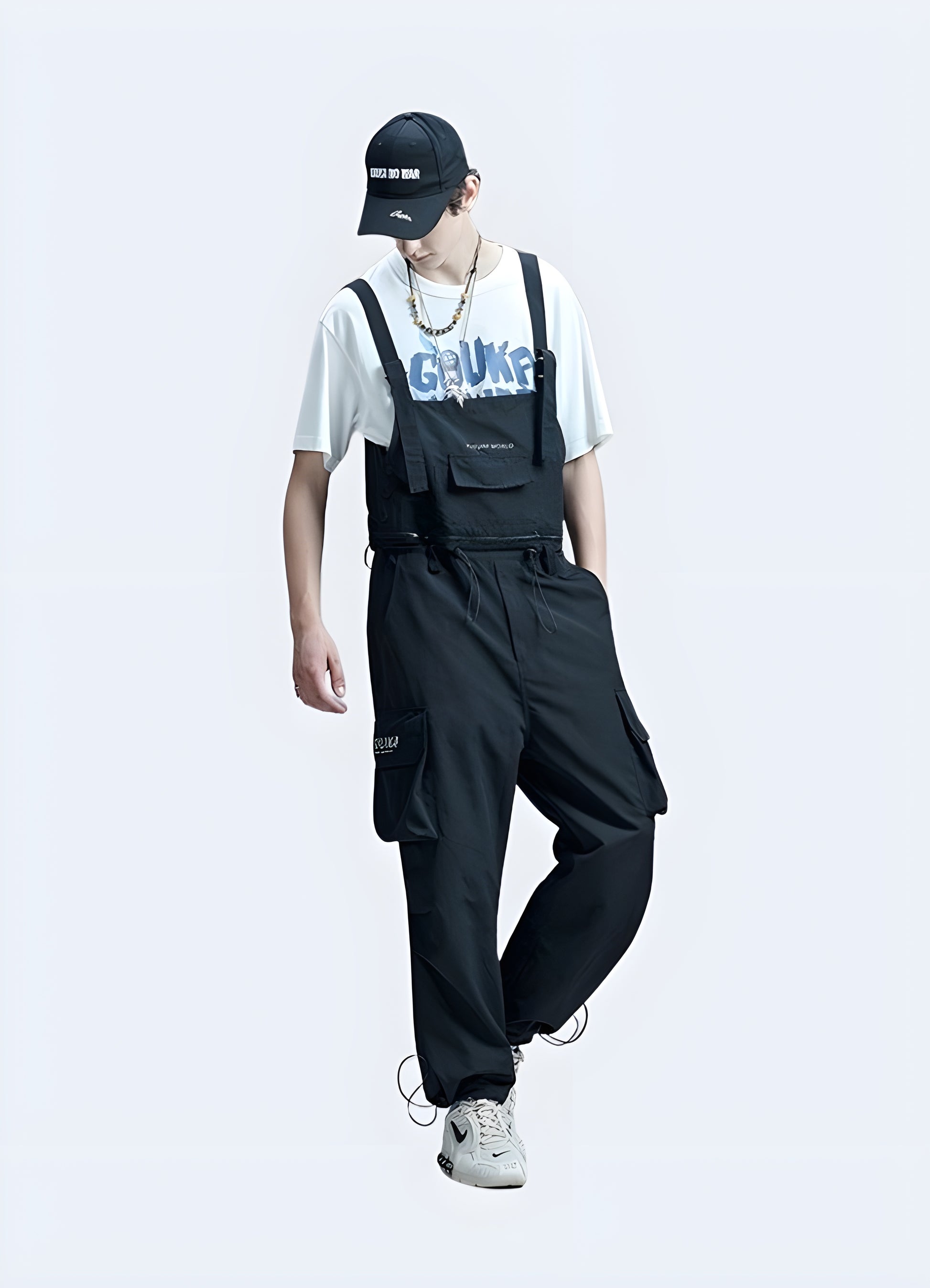 Side view of men's techwear overalls with multiple pockets and modern utilitarian design.