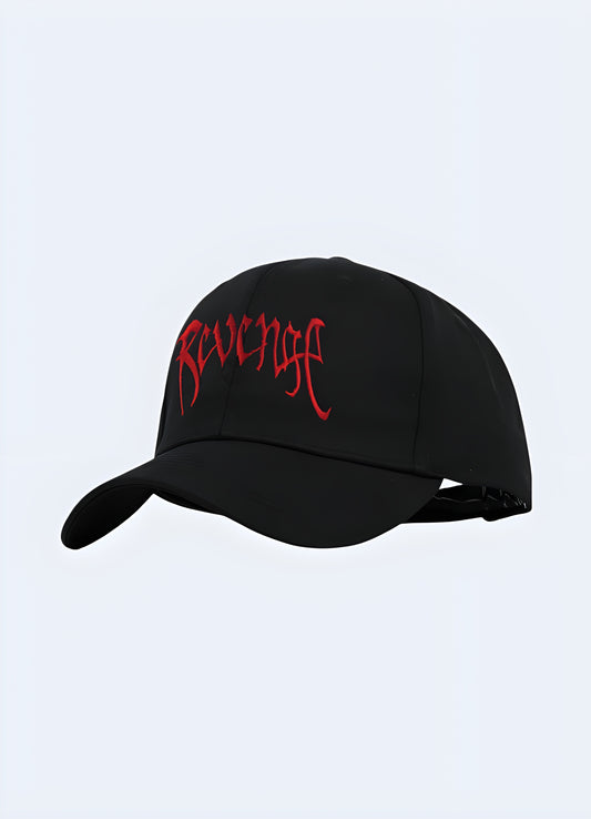 A black "Revenge" hat displayed from the front-side view, showcasing its sleek design with prominent lettering across the front.