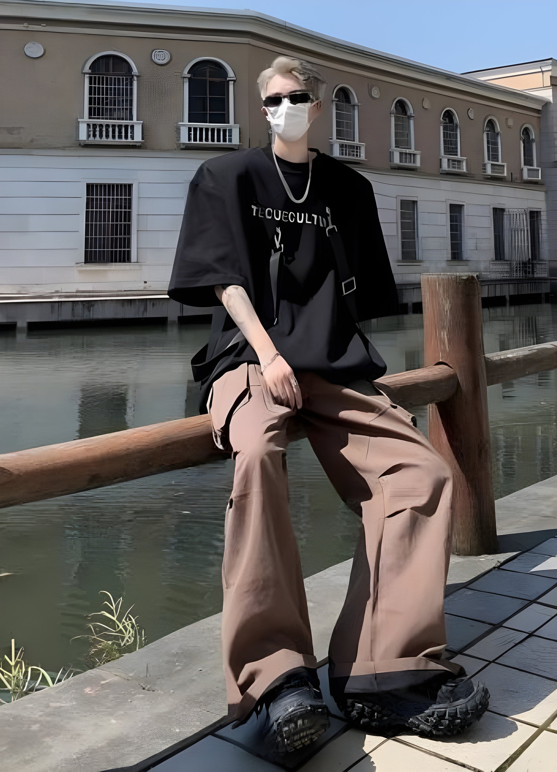 Its oversized design, painted in a rich noir, is accentuated by an arrangement of tactical straps. 