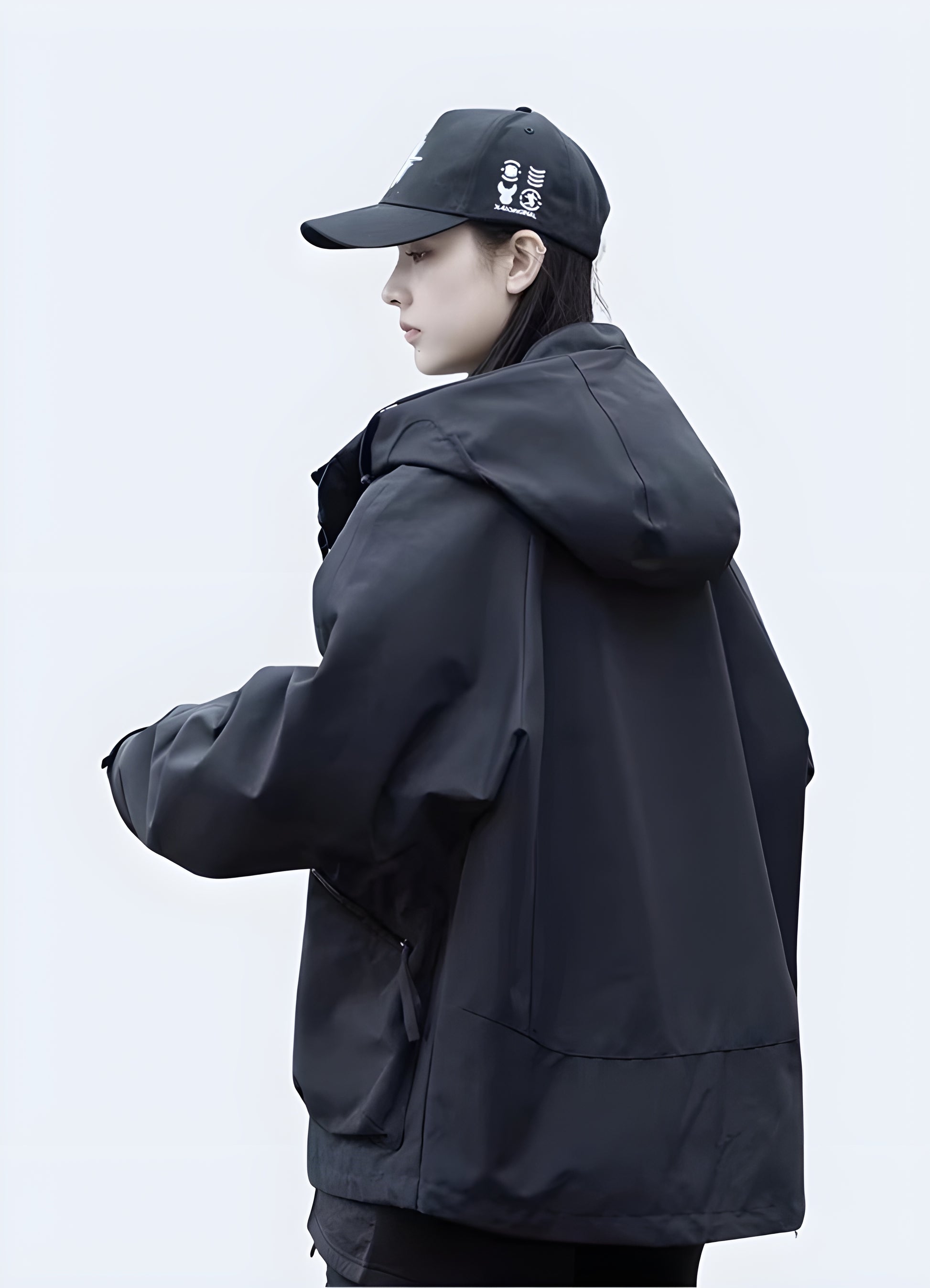 Side view of techwear raincoat in black – regular fit with ergonomic cut, lightweight and breathable, ideal for urban layering and weather protection, streetwear-inspired versatile jacket for men.