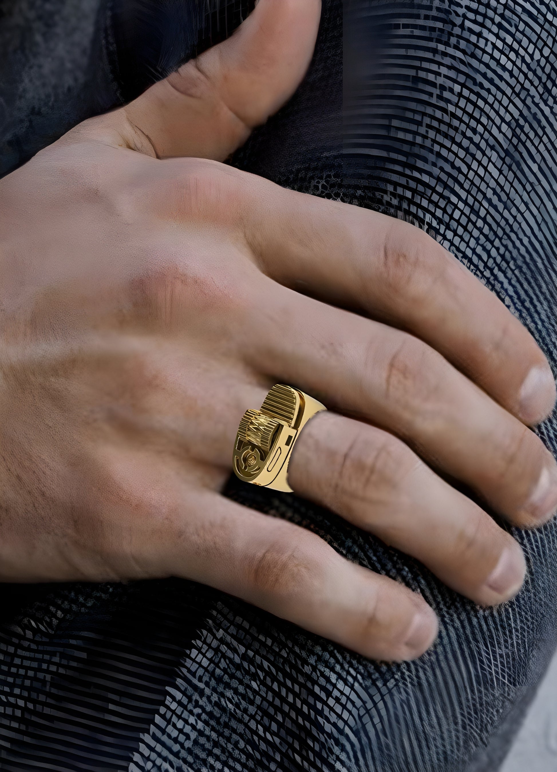 Person wearing a gold lighter ring, displayed in a front view to showcase its unique design and modern aesthetic.