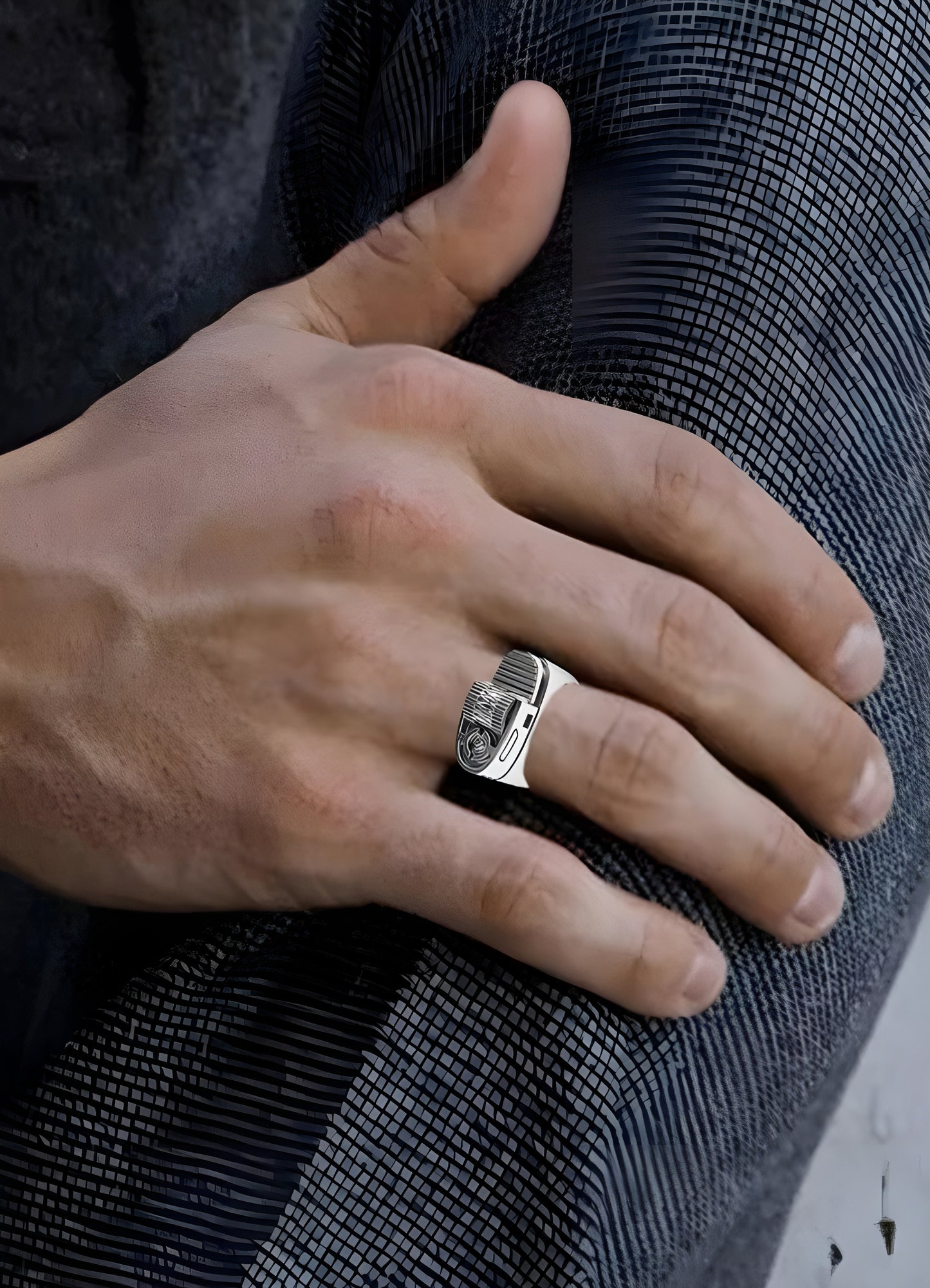 Person wearing a silver lighter ring, displayed in a front view to showcase its unique design and modern aesthetic.