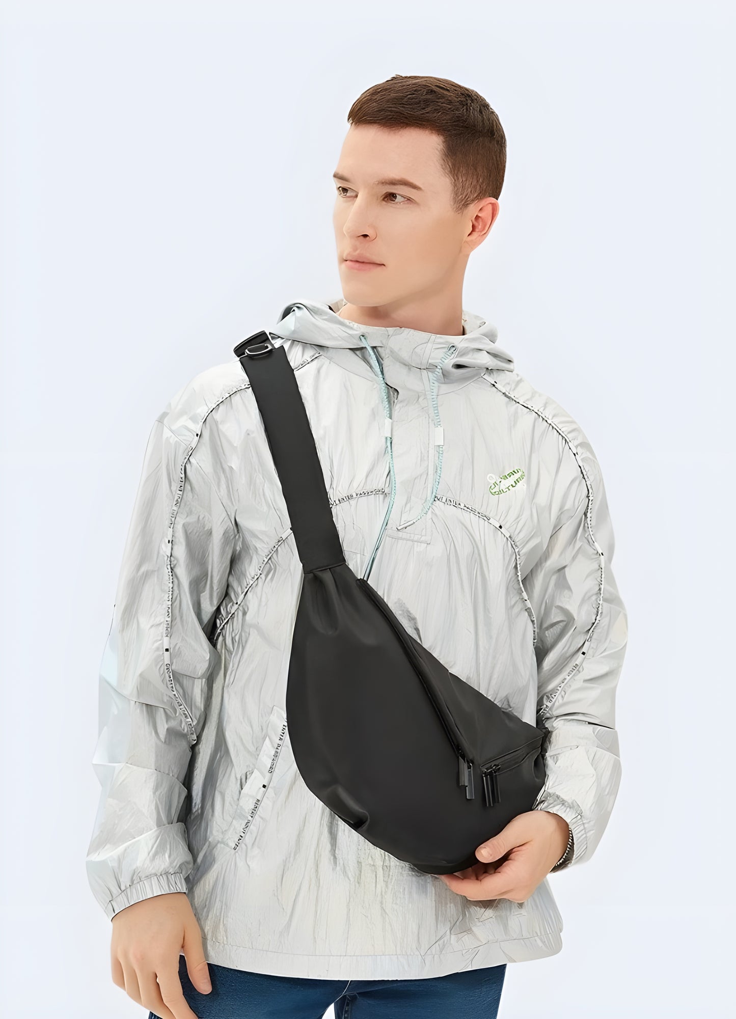 Male model wearing black urban sling bag – front view showcasing techwear-style crossbody chest bag with multiple secure pockets and adjustable strap, perfect for city wear and travel.