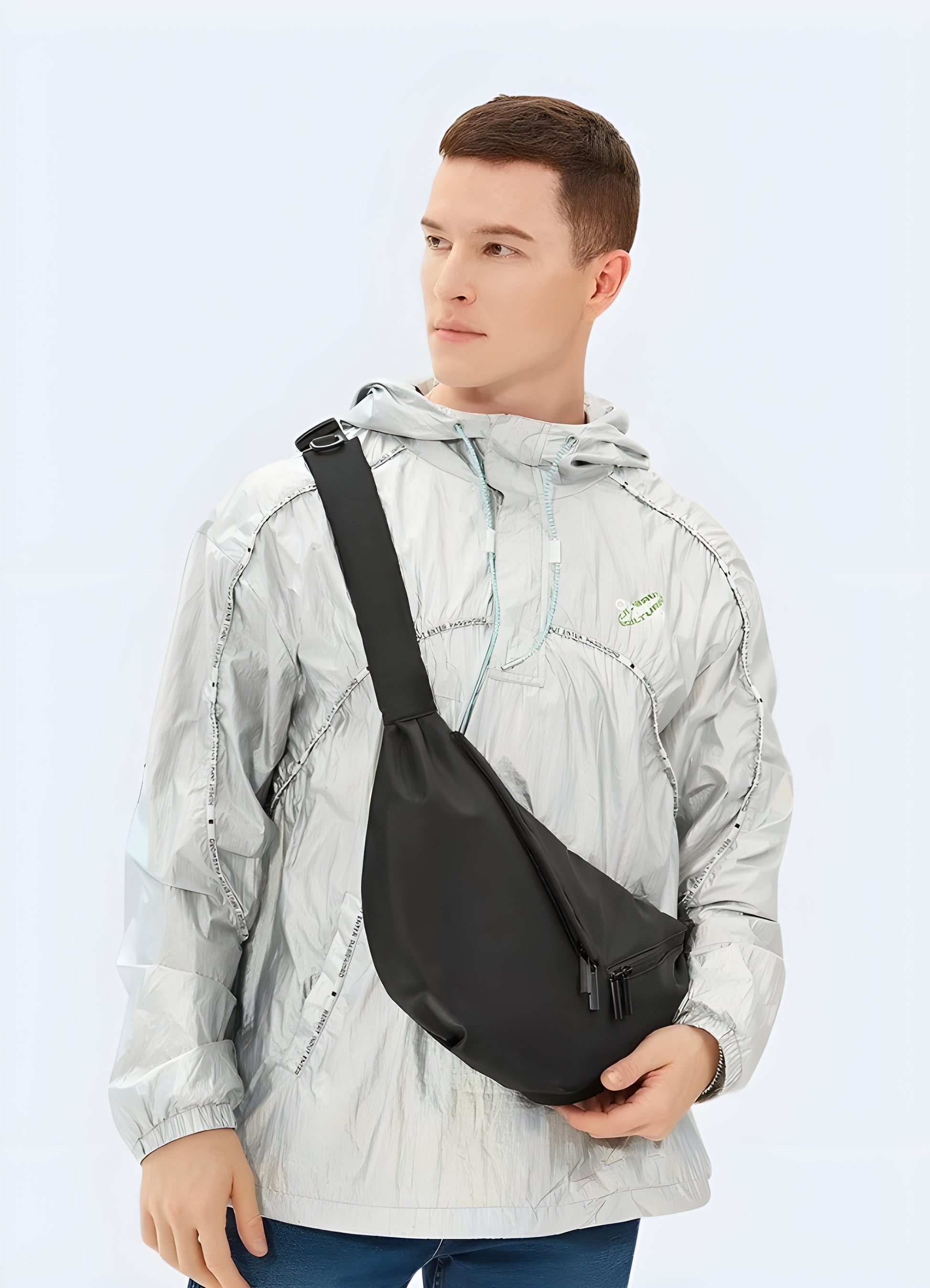 Male model wearing black urban sling bag – front view showcasing techwear-style crossbody chest bag with multiple secure pockets and adjustable strap, perfect for city wear and travel.