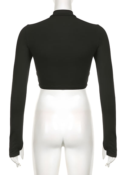 Back view of a woman in a stylish black turtleneck bodysuit, showcasing its smooth silhouette and seamless fit. This timeless piece appeals to the UK’s trendsetters, offering a chic, minimalist look that can easily transition between day and night outfits.